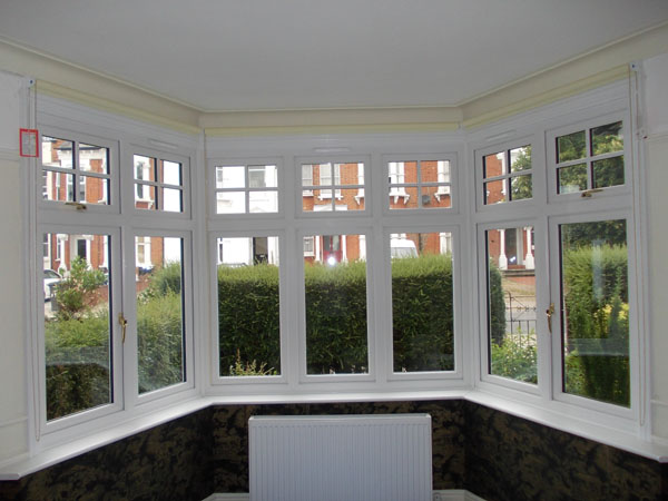 roller blinds in a three sided bay window with the blinds raised