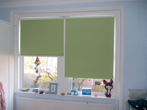 blackout roller blinds being lowered showing the lightwash at the edges