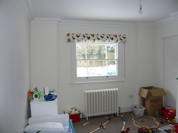 blackout roman blind in a Prestigious fabric folded at top of window