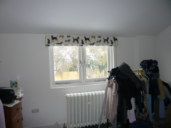 roman blind stacked at top of window