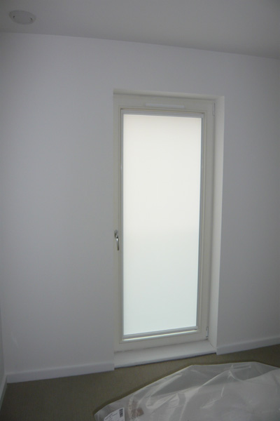 White framed nano blind, top down bottom up for door, blind covering the glass