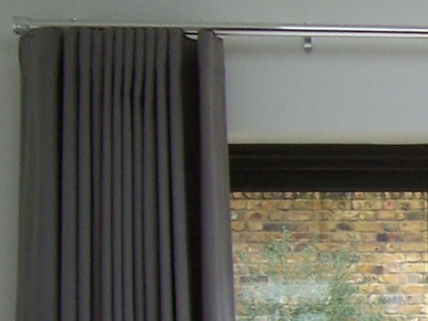 Wave system curtains stacking back neatly on chrome 30mm Silent Gliss Metropole - close up left