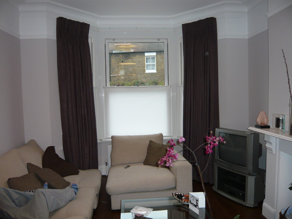 Faux suede curtains on a track with bottom up blinds fitted to UPVC windows