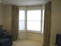 Sanderson print, interlined, pinch pleated, hung from a bay window pole with roller blinds for privacy Tufnell Park