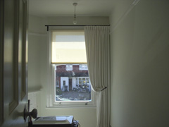 Single curtain on pole at asymetric window Crouch End