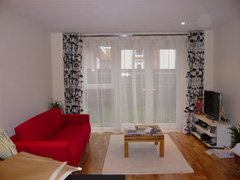 eyeletted curtains on double chrome pole with voiles behind Islington