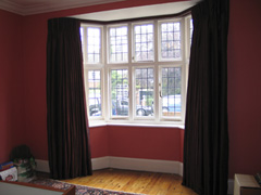 Red Faux Silk interlined and pinch pleated mounted on covered fascia / covered lath Highgate