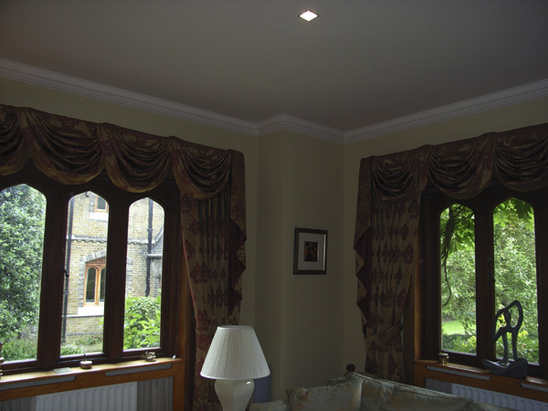 Very traditional swags and tails complement the right window.