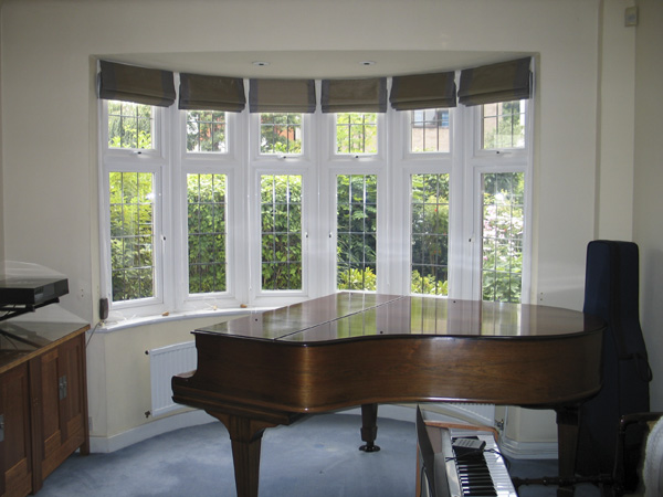 Roman blinds all round bay window in Andrew Martin silk