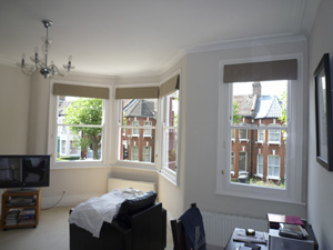 roman blinds to a bay and straight window leave a feeling of uncluttered spaciousness Tottenham