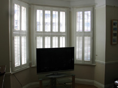 Wooden shutters with 47mm louvres, tier on tier in silk white Enfield
