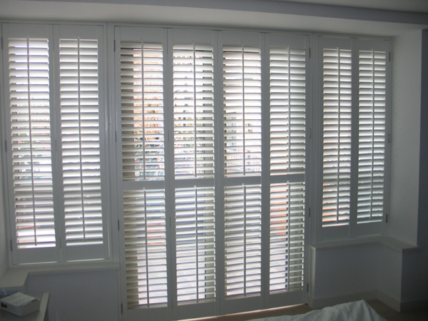 patio door and windows make a T-shape of shutters