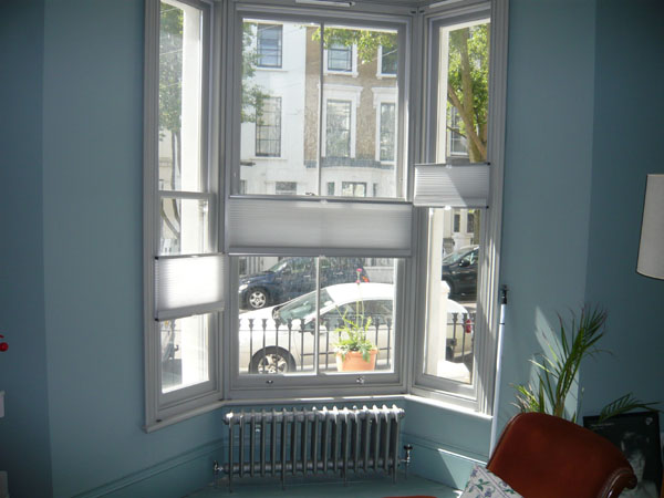 top down bottom up duette blinds covering random portions of this North London bay window