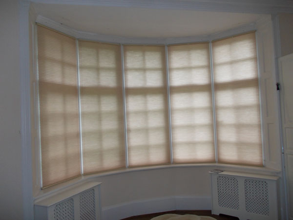 Bottom Up Top Down duette blinds installed in bay window for privacy and insulation, positioned to cover whole window
