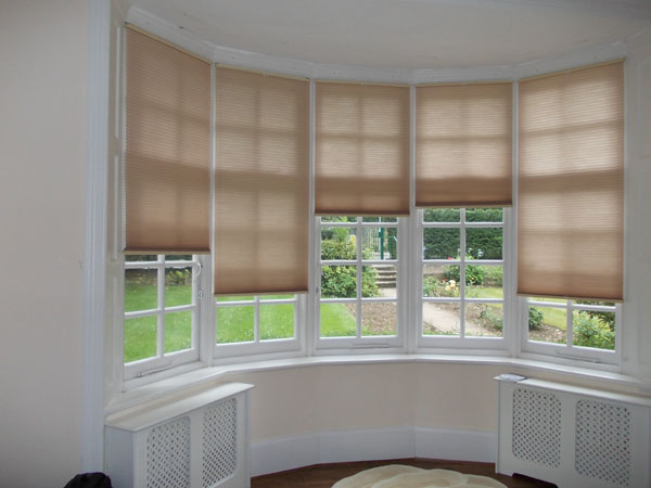 Bottom Up Top Down duette blinds installed in bay window for privacy and insulation, positioned top down for shade