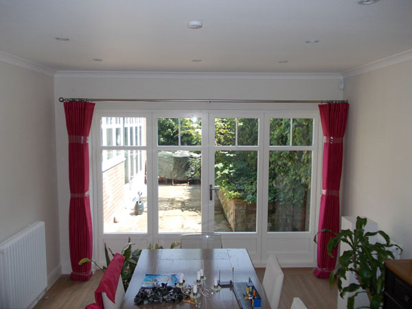 curtain pole with curtains dressed and tied to set the pleats