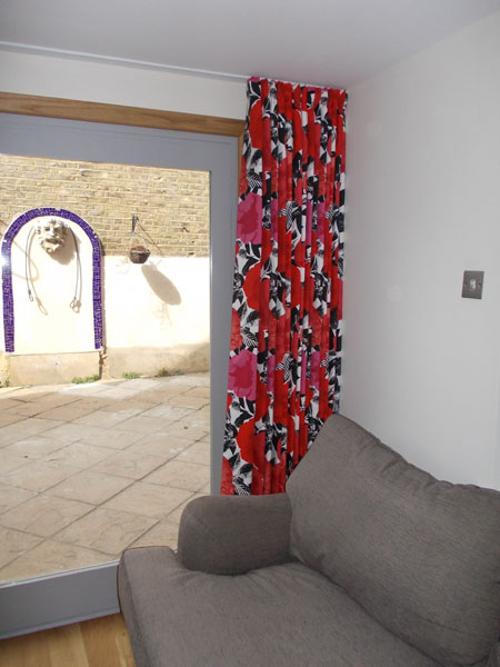 A single wave style curtain in Prestigious Madone Poppy close up
