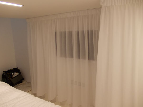 voile drape disguising the TV on the wall