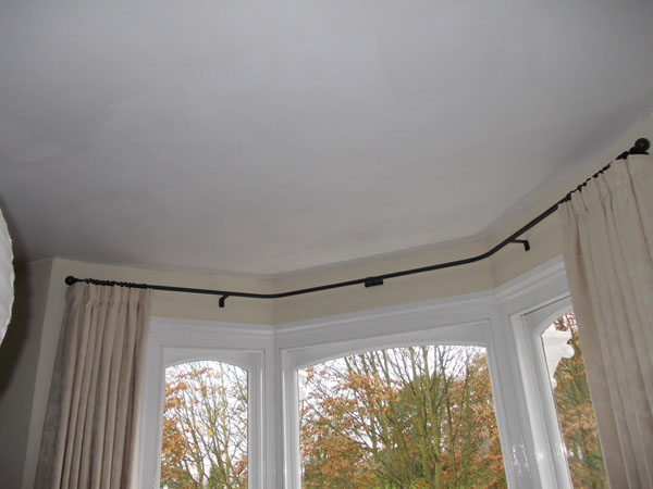 close up of wave style curtain under a pole