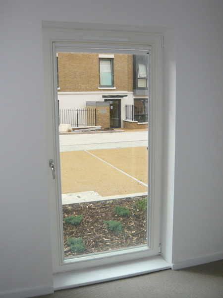 white luxaflex nano blind fitted to glass door - both cassettes at the top