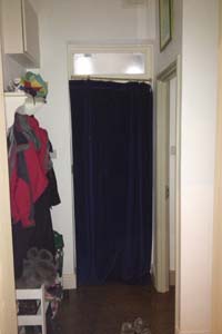 Portiere rod and interlined curtain fitted to Front Door in North London - the door is closed