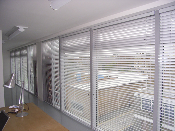 50mm aluminium venetian blinds covering an entire wall of this modern studio / workshop on the borders of Hackney and Islington in North London