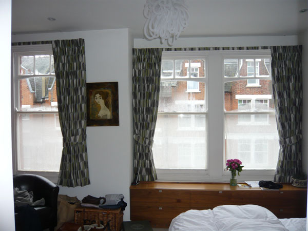 Pinch Pleat curtains with Blackout Lining and a covered fascia make this a very dark North London bedroom