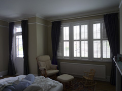 Harlequin interlined on white 50mm wooden poles with plantation shutters Tufnell Park