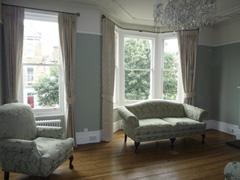 Traditional Sanderson damask interlined and pinch pleated on bay window and straight pole Maida Vale West London