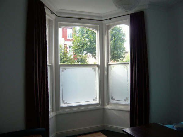 Artificial silk curtains on bay window pole