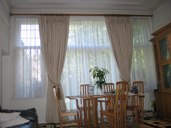 Calico curtains suspended from a 50mm wooden pole. Recess brackets at each end