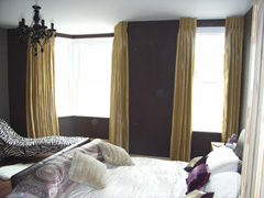 Faux silk curtains with a corded white steel curtain track fitted to ceiling Wood Green