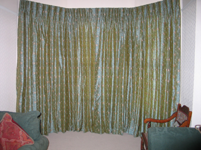 French cloque work in silk, interlined and pinch pleated curtains, corded steel bay window track fixed to the top edge of the window architrave 