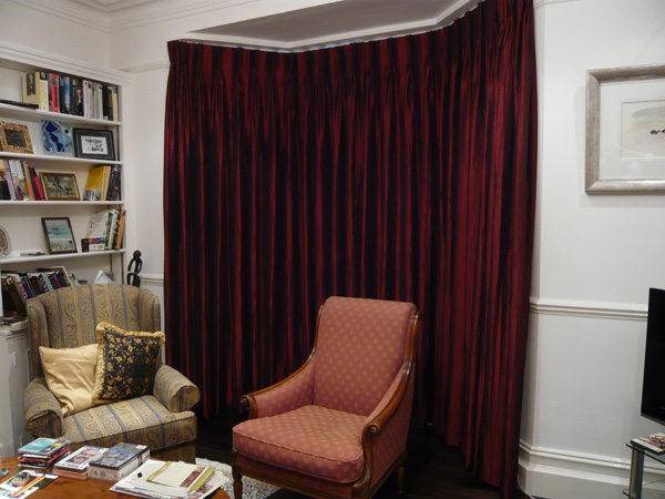 Faux silk interlined and pinch pleated on bay window track - closed