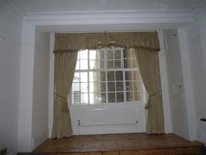 Gold damask curtains with gathered shaped pelmet with braid West End
