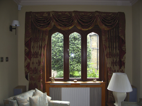 Very traditional swags and tails complement the right window.