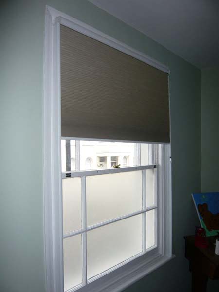 blackout duette blind half lowered inside side channels