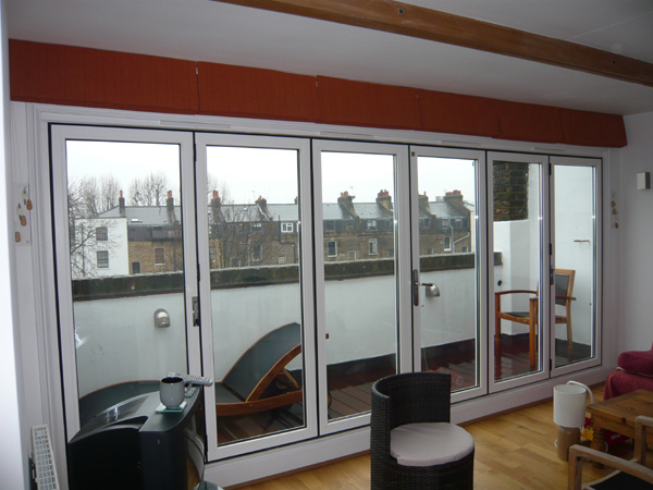 Blackout roman blinds installed in Herts, stacked above the patio doors