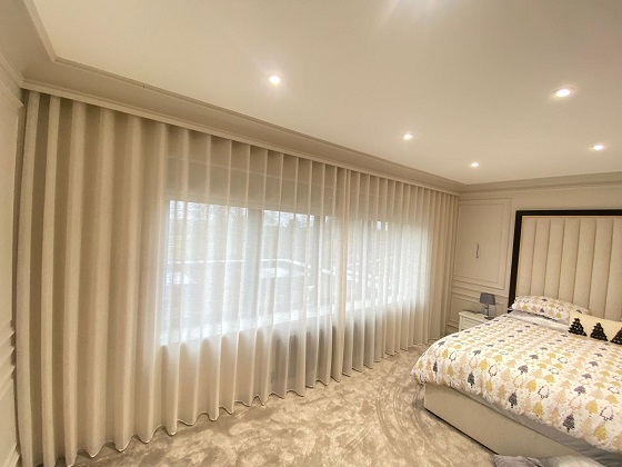 wave sheers provide this bedroom with privacy