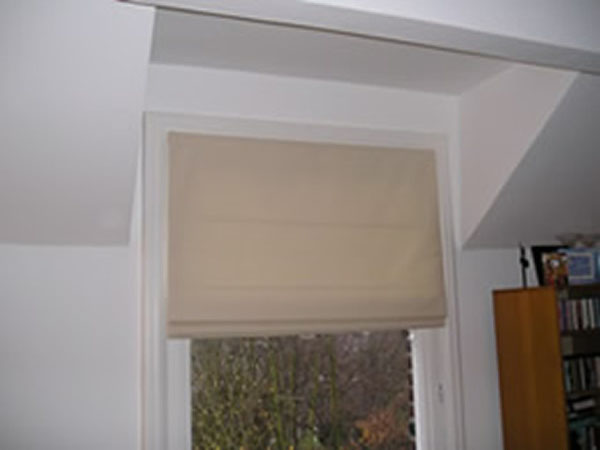 A simple Roman Blind leaves a small room appearing larger. With the top of this window set in a dormer there is very little space for curtains and curtains would reduce the amount of light available