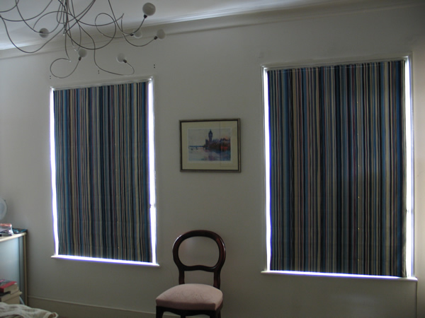 Blackout roman blinds - light does not pass through blackout lining but you do get light wash at the edges