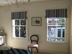 Blackout Roman blinds in a vertically striped fabric Islington