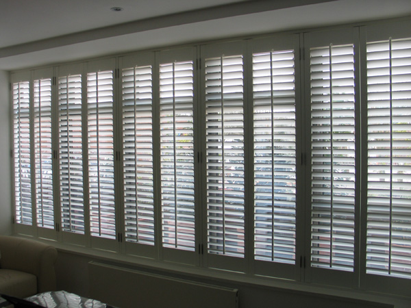 a wall of shutters mimicking the windows behind