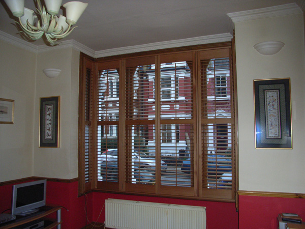 Attractive and efficient. Oiled Western Red Cedar shutters with 63mm louvres positioned above the convection radiator. 