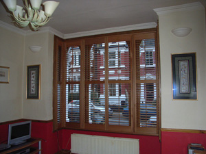 Attractive and efficient. Oiled Western Red Cedar shutters with 63mm louvres Archway