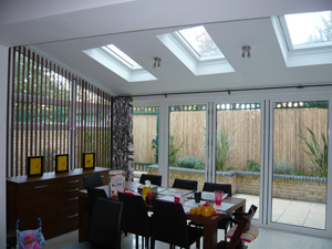 Marimekko curtains on a 7m long pole with a sloping vertical blind installed in Tufnell Park North London